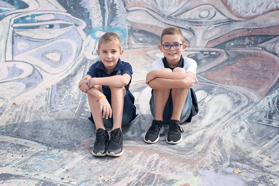 Deux frangins assis au milieu du skatepark.