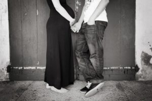 Portrait d'un jeune couple en noir et blanc se tenant la main.